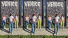 A video compilation of Nina Be baby tee designs worn by various pretty girls in different locations with close ups of the colorful baby tee graphics.